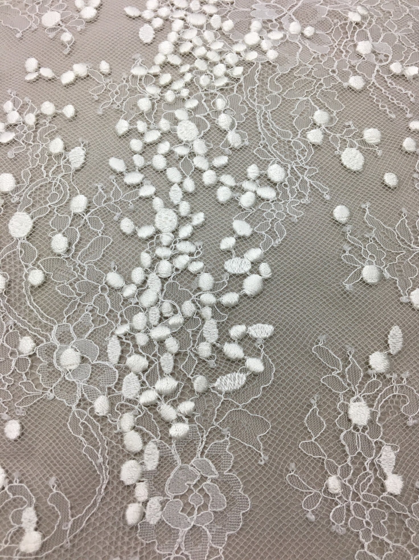 Ivory Embroidered Lace — featuring scalloped edges, eyelash detail and floral motifs, in nylon and viscose, 130cm wide