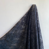 Black Glitter Floral Lace — featuring scalloped edges and floral motifs, in nylon, 160cm wide