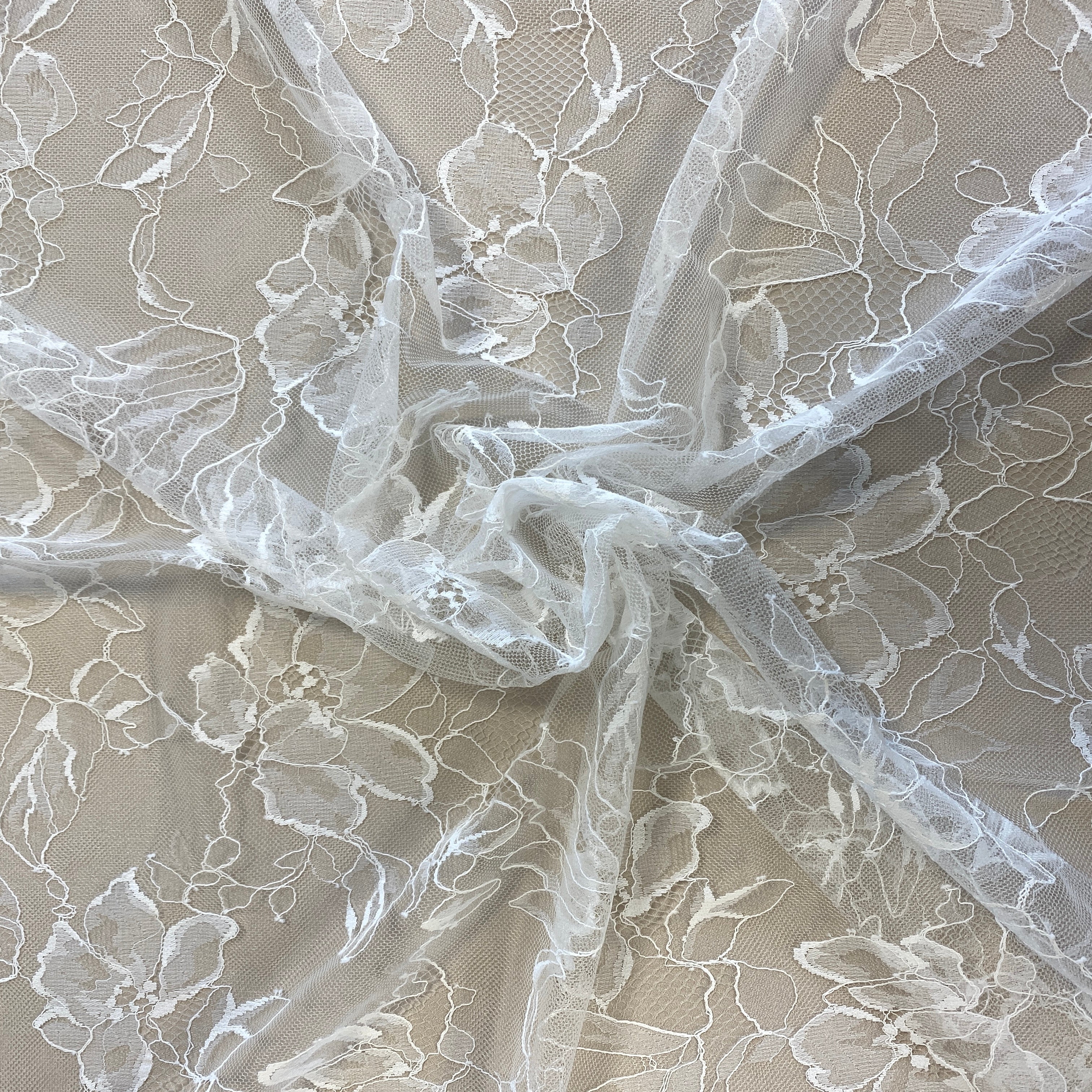 Ivory Floral Lace — featuring scalloped edges, eyelash detail and floral motifs, in nylon, 140cm wide