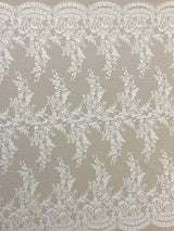 Ivory Floral Lace — featuring scalloped edges, eyelash detail and floral motifs, in nylon, 150cm wide