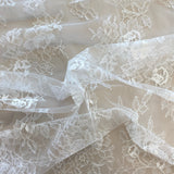 Ivory Fine Lace — featuring scalloped edges and floral motifs, 140cm wide