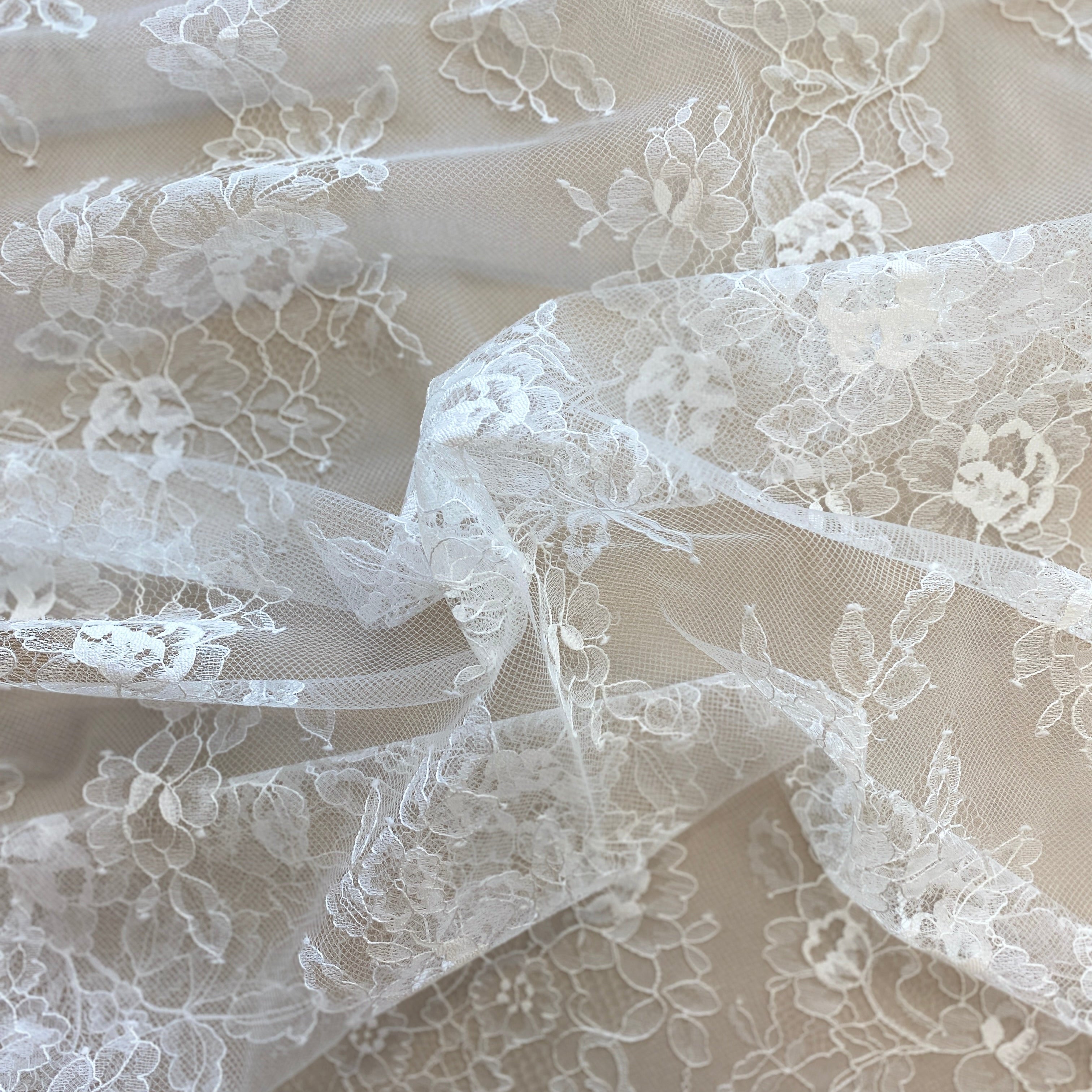 Ivory Fine Lace — featuring scalloped edges and floral motifs, 140cm wide