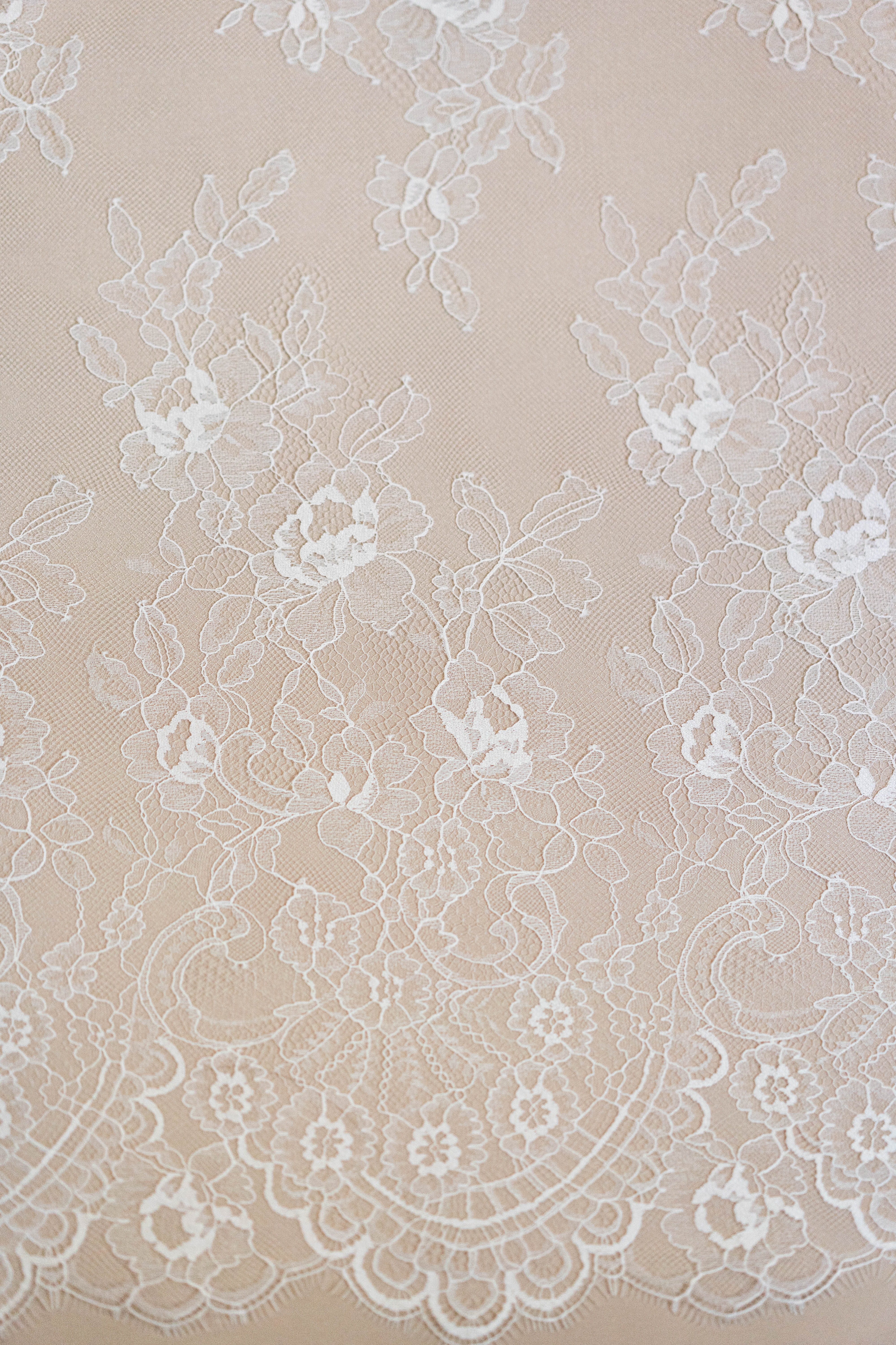 Ivory Fine Lace — featuring scalloped edges and floral motifs, 140cm wide