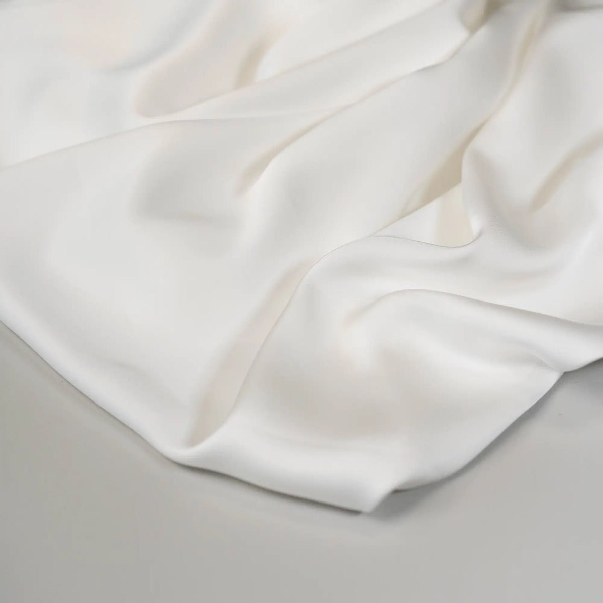 Ivory Faux Acetate Satin — mid-weight double-faced polyester satin with a delustered finish, fluid drape and slight stretch