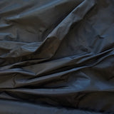 Black Taffeta — a mid-weight silk taffeta with a smooth texture and crisp handle, 100% silk