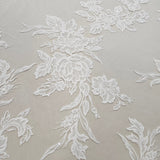 Ivory Floral Embroidered Tulle — featuring floral motifs and a border design, 60% rayon 40% nylon, 140cm wide