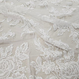 Ivory Floral Embroidered Tulle — featuring floral motifs and a border design, 60% rayon 40% nylon, 140cm wide