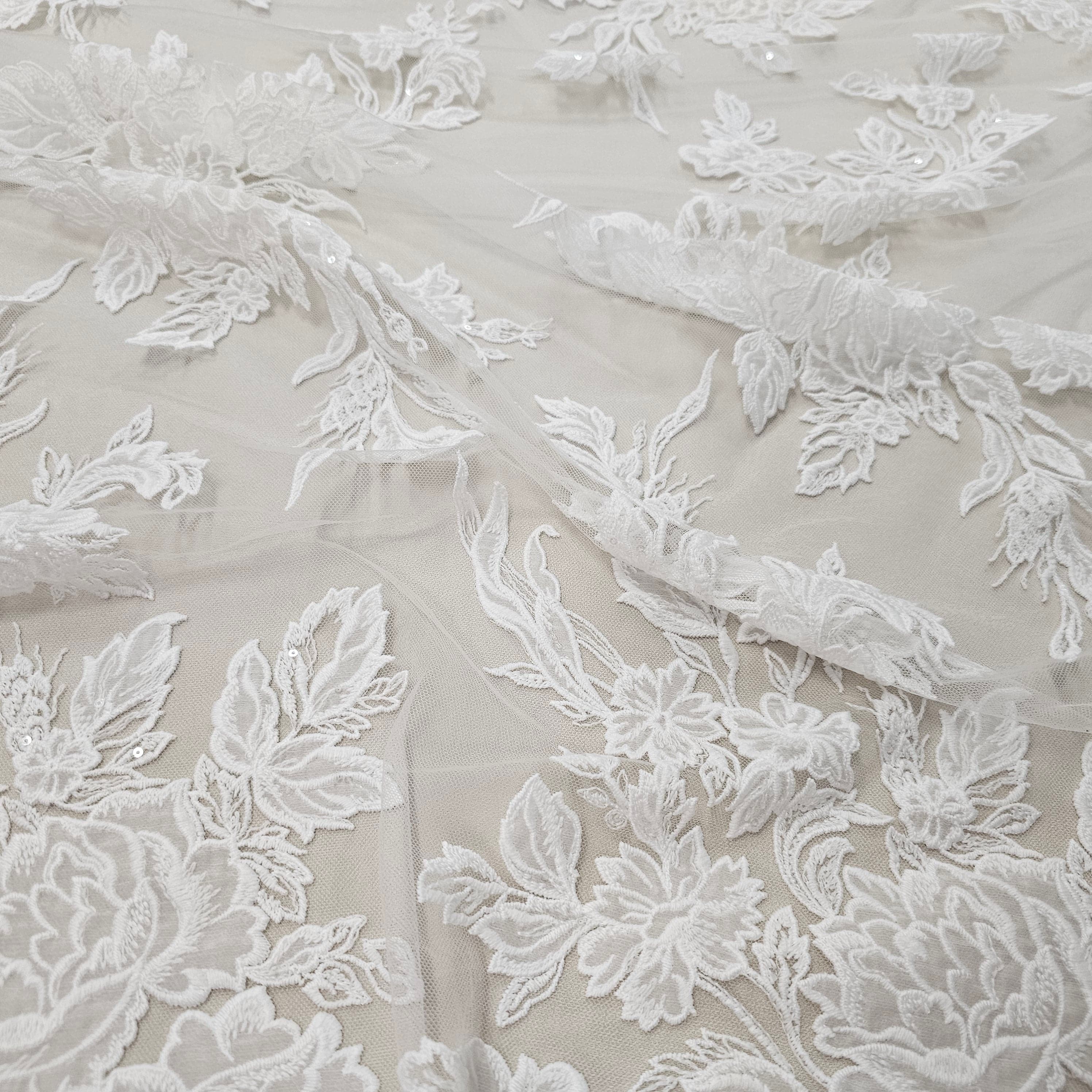 Ivory Floral Embroidered Tulle — featuring floral motifs and a border design, 60% rayon 40% nylon, 140cm wide
