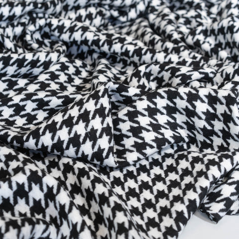 Close-up of black and white houndstooth pattern fabric, wool cotton blend coating fabric