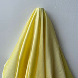 Pastel Yellow Polyester Dupion — mid-weight and crisp with a lightly slubbed texture, 100% polyester, 140cm wide