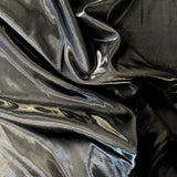 Black Liquid Satin — smooth and glossy with a liquid, wet-look shimmer, 100% polyester, 150cm wide
