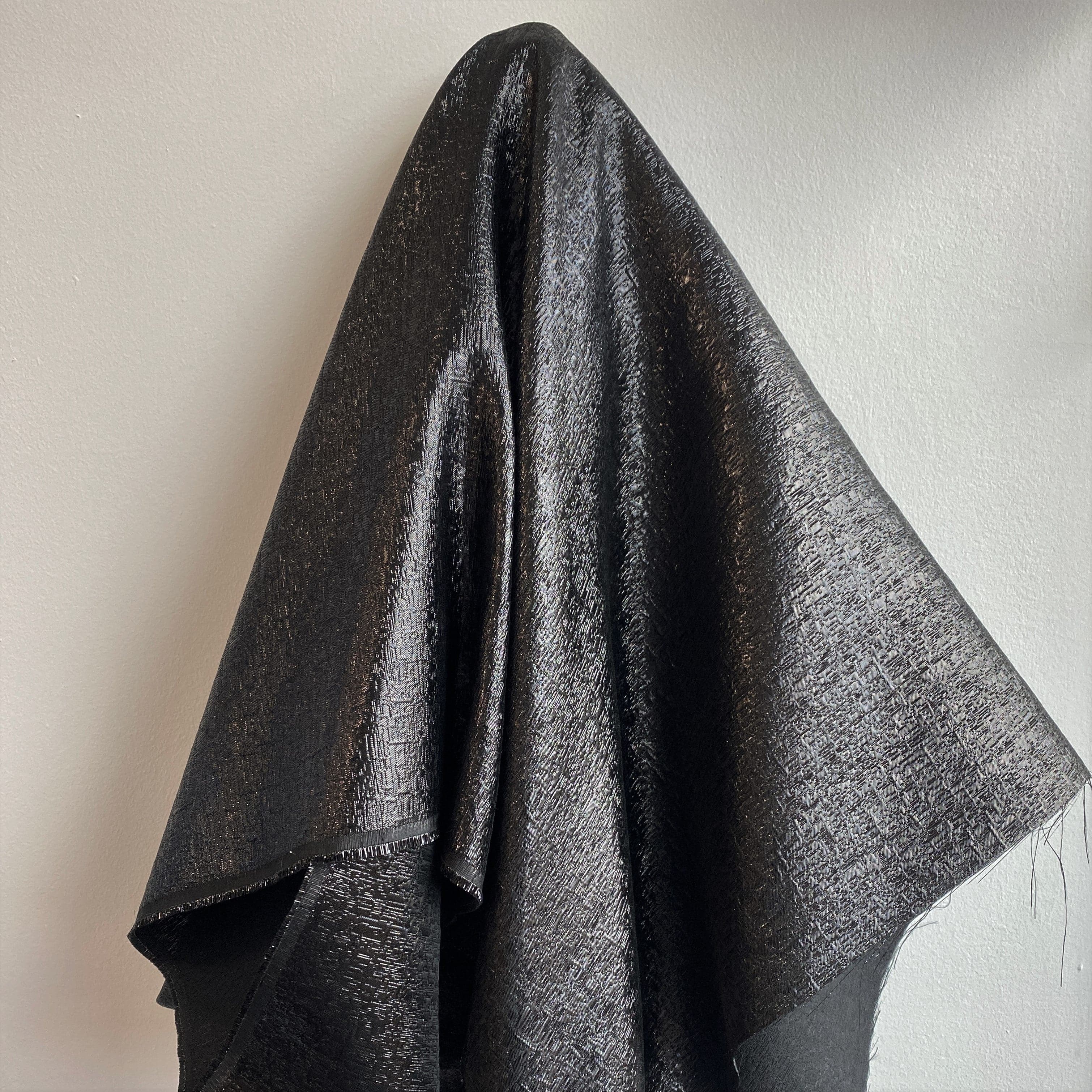 Black Metallic Jacquard — featuring a woven metallic jacquard design with a soft feel and stiff drape, 140cm wide