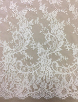 Ivory Fine Chantilly lace — featuring scalloped edges, eyelash detail and floral motifs, in viscose, 135cm wide