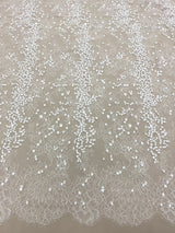 Ivory Embroidered Lace — featuring scalloped edges, eyelash detail and floral motifs, in nylon and viscose, 130cm wide