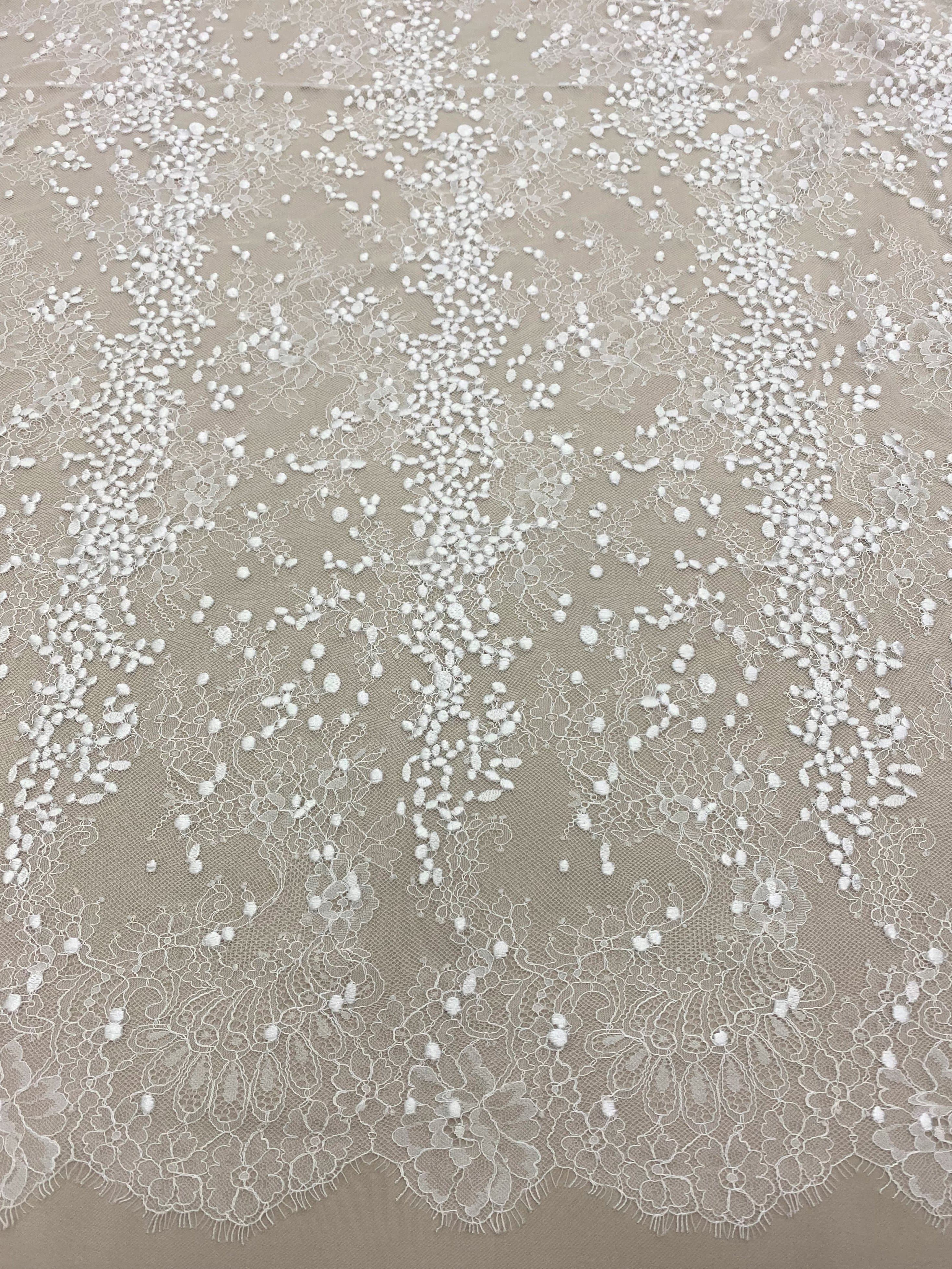 Ivory Embroidered Lace — featuring scalloped edges, eyelash detail and floral motifs, in nylon and viscose, 130cm wide