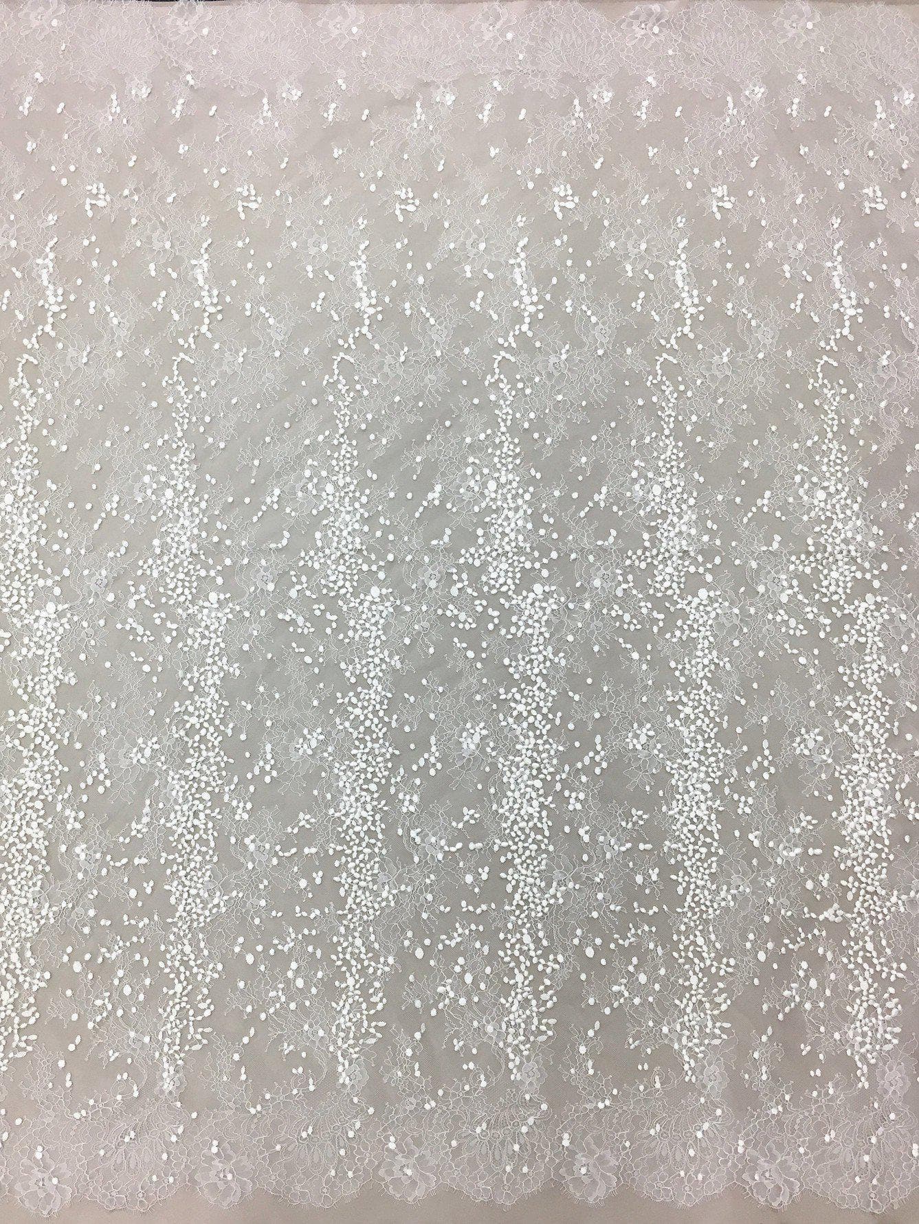 Ivory Embroidered Lace — featuring scalloped edges, eyelash detail and floral motifs, in nylon and viscose, 130cm wide
