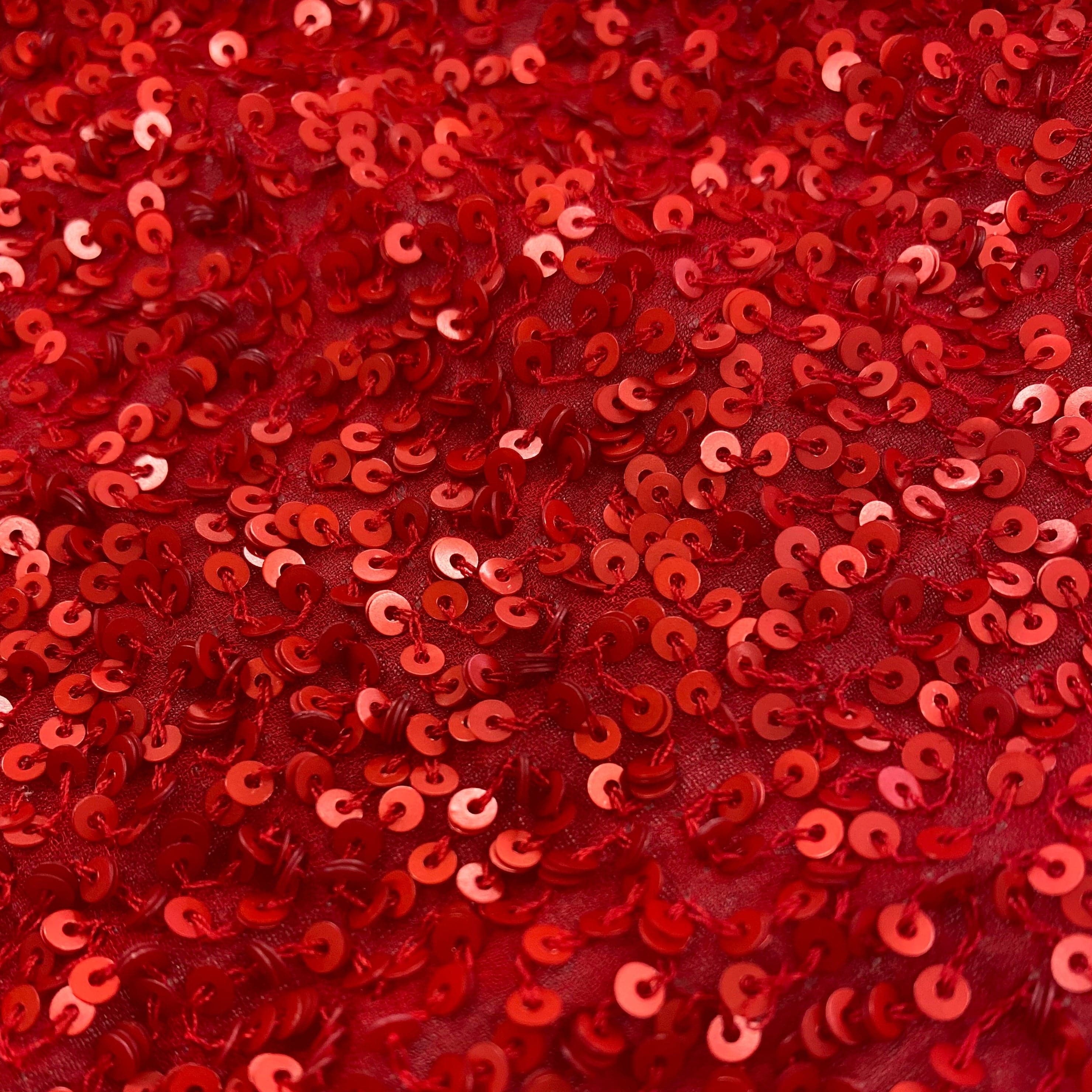 Red Sequin Georgette — heavily sequined on a 100% silk georgette base, with sequins running the length, 110cm wide