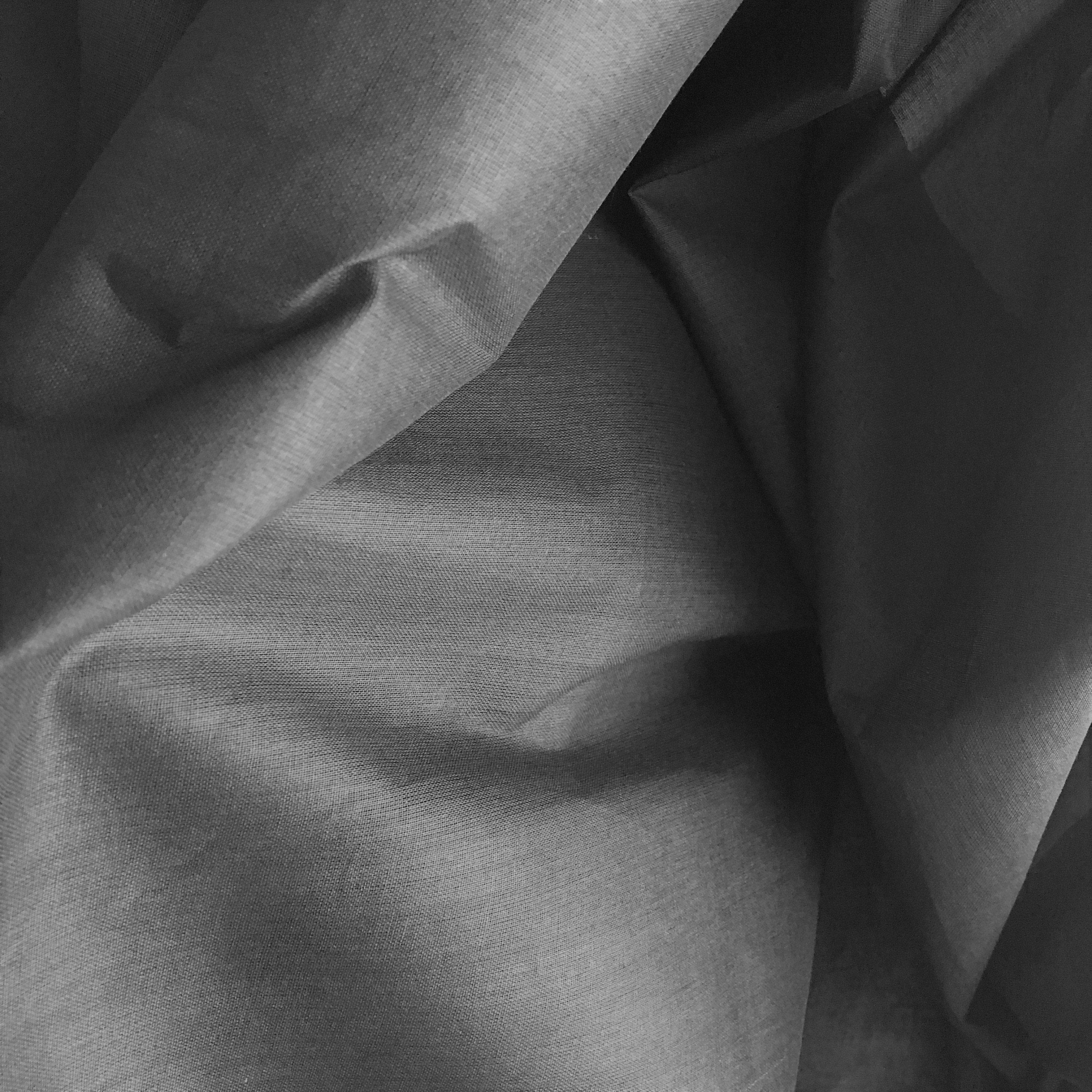 Black Cotton Organdy — a lightweight, semi-sheer cotton with a crisp, stiff handle, 100% cotton