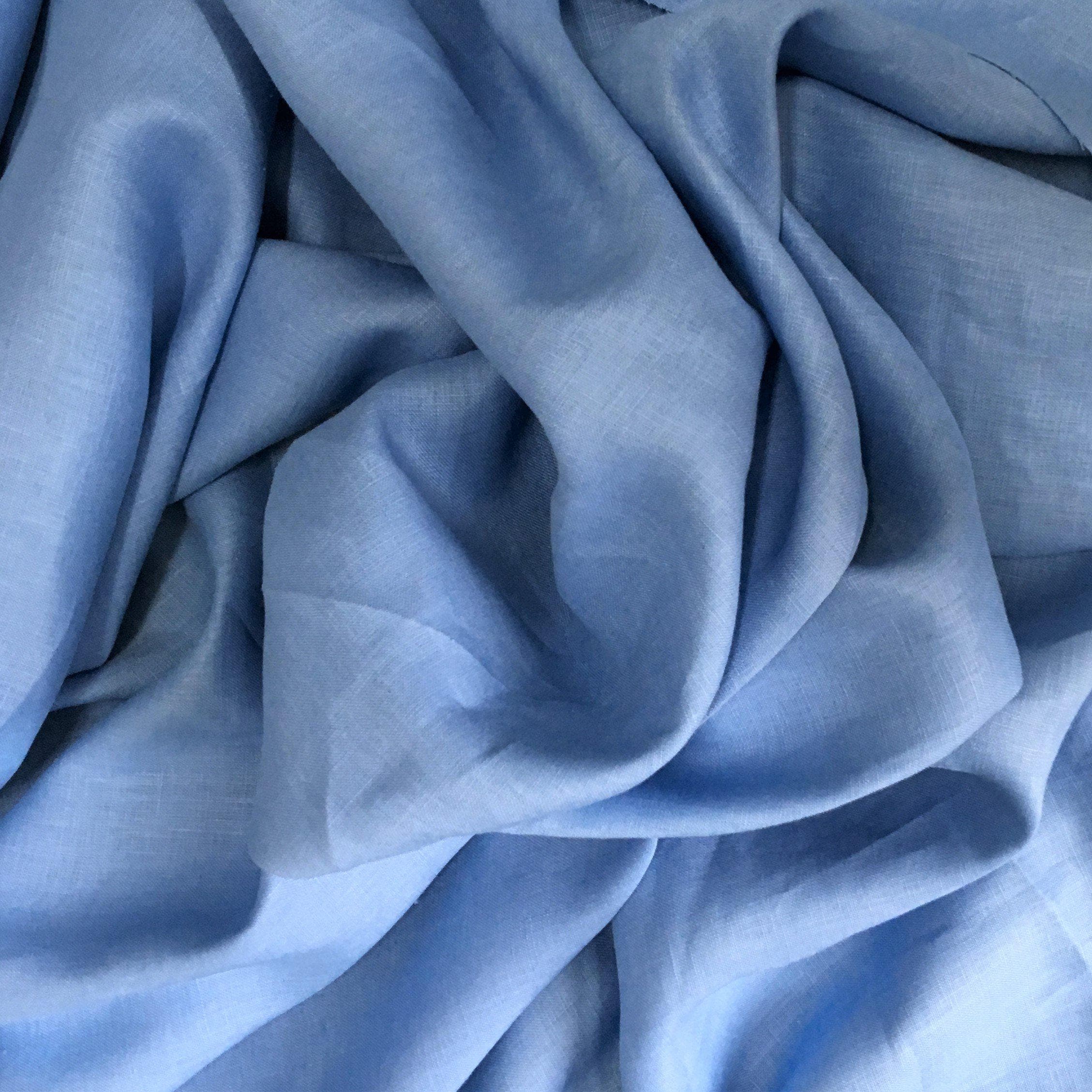 Cornflower Linen — mid-weight plain-weave linen with a slightly crisp handle that softens with wear, 100% linen, 135cm wide