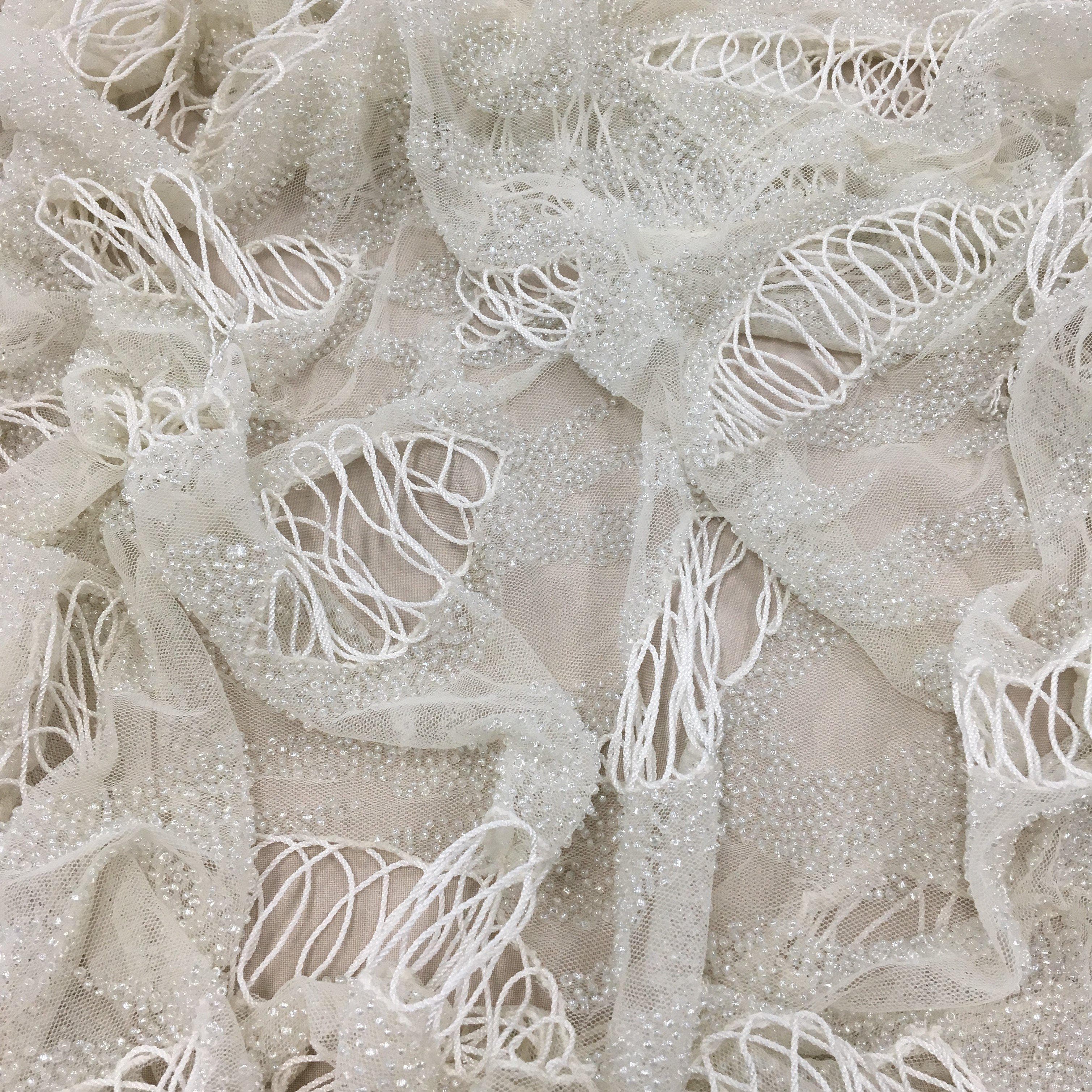 Ivory Hand Beaded Tulle — featuring a corded texture and hand-beading, 100% nylon, 110cm wide