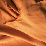Burnt Orange Linen — mid-weight plain-weave linen with a slightly crisp handle that softens with wear, 100% linen, 135cm wide