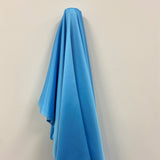 Pale Blue Stretch Polyester Lining — lightweight with a satin finish, matte reverse and gentle stretch, in polyester
